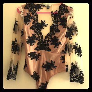 Nude body suit with black floral design
